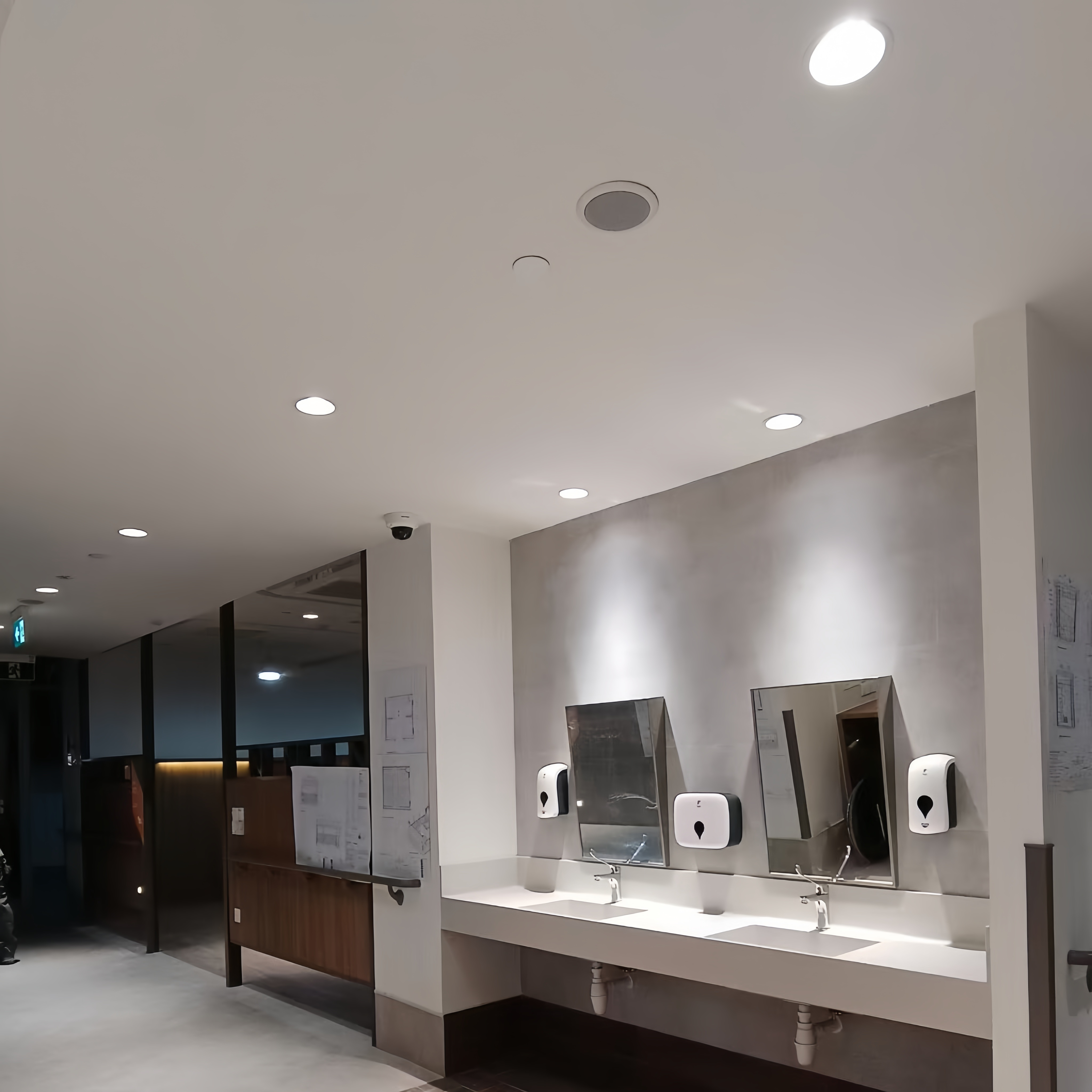 Recessed LED lighting above the washbasin area in a public interior